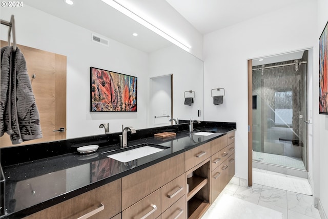 bathroom featuring vanity and a shower with door