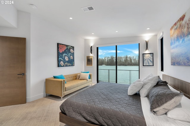 bedroom with access to outside, a water view, and light colored carpet