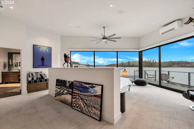 living room featuring a water view, plenty of natural light, a wall mounted AC, and ceiling fan