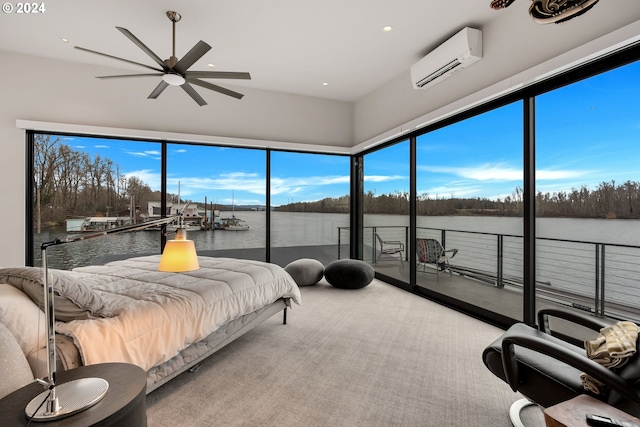 carpeted bedroom featuring ceiling fan, a water view, and a wall mounted AC