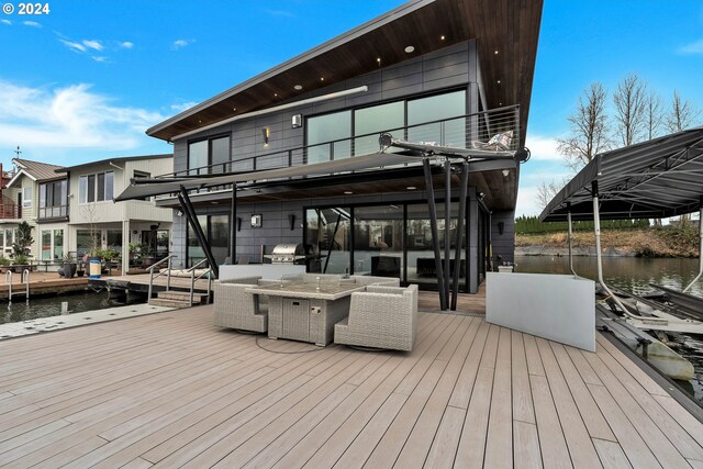 exterior space featuring outdoor lounge area and a water view