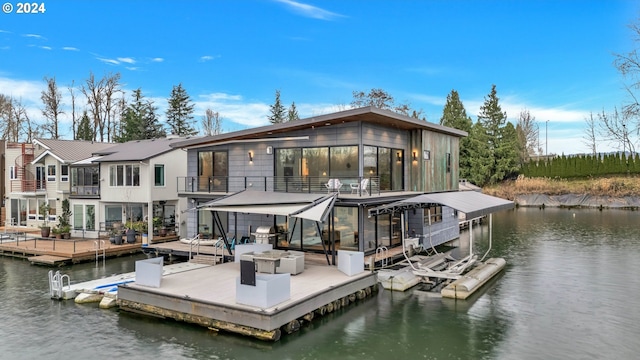 view of dock featuring a water view and a balcony