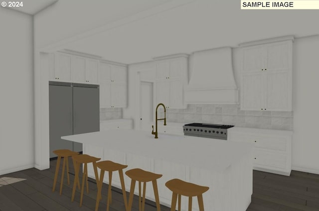 kitchen with white cabinets, dark hardwood / wood-style flooring, backsplash, and a center island with sink