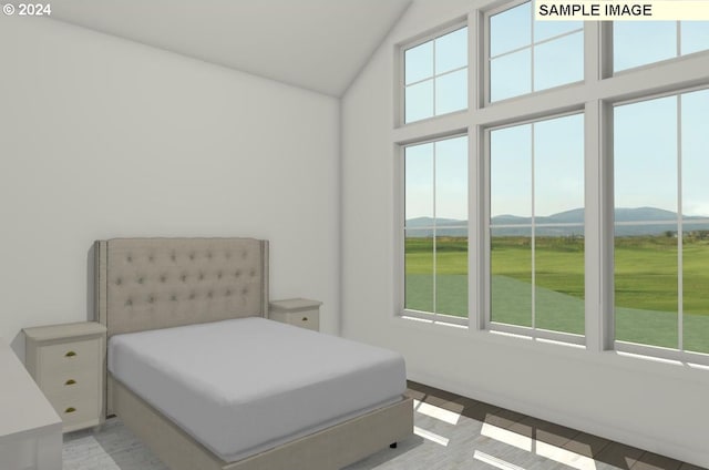 bedroom featuring multiple windows, a mountain view, and lofted ceiling