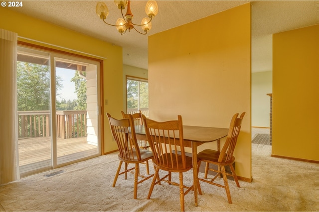 dining area with light colored carpet, a textured ceiling, and an inviting chandelier