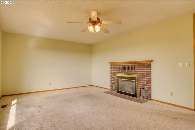 unfurnished living room with carpet, ceiling fan, a fireplace, and a textured ceiling