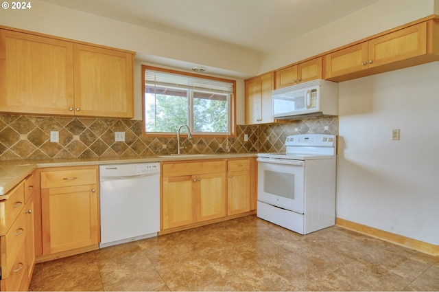 kitchen with light brown cabinets, white appliances, sink, and tasteful backsplash