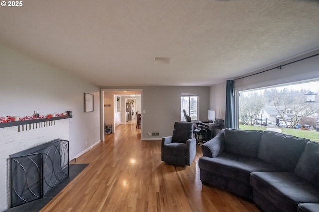 living room with hardwood / wood-style floors and a textured ceiling