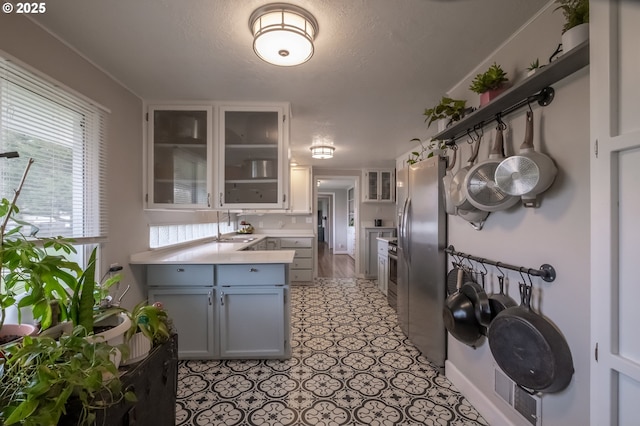 kitchen with appliances with stainless steel finishes, white cabinets, and a textured ceiling