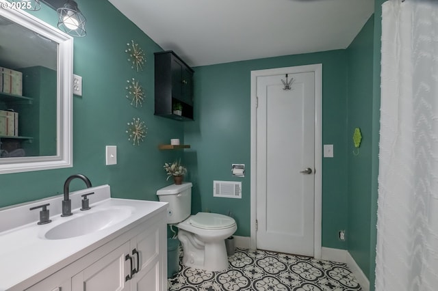 bathroom with vanity, tile patterned floors, and toilet