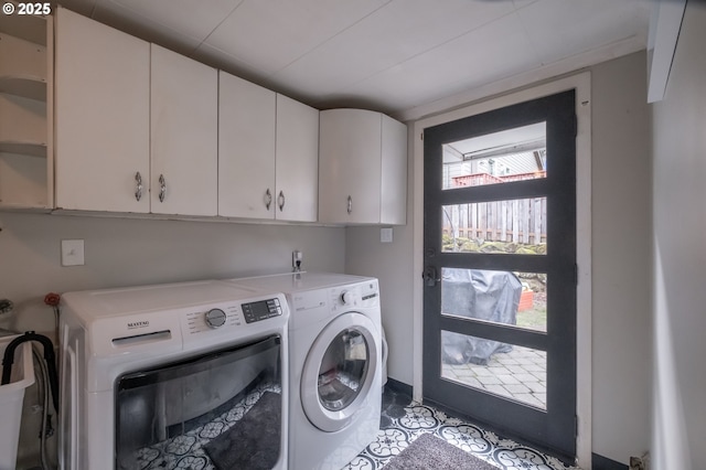 laundry area featuring cabinets and independent washer and dryer