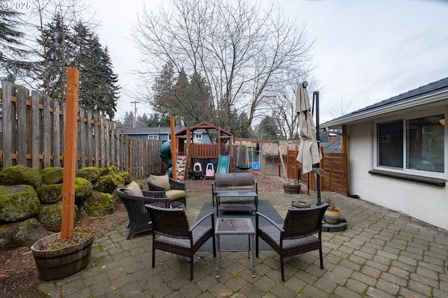 view of patio featuring outdoor lounge area and a playground