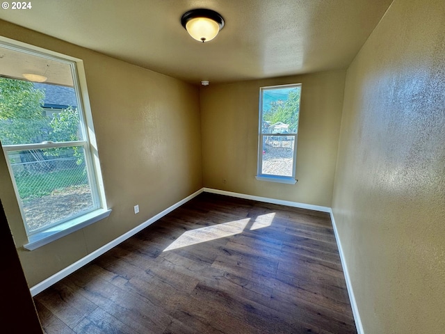 unfurnished room featuring dark hardwood / wood-style floors