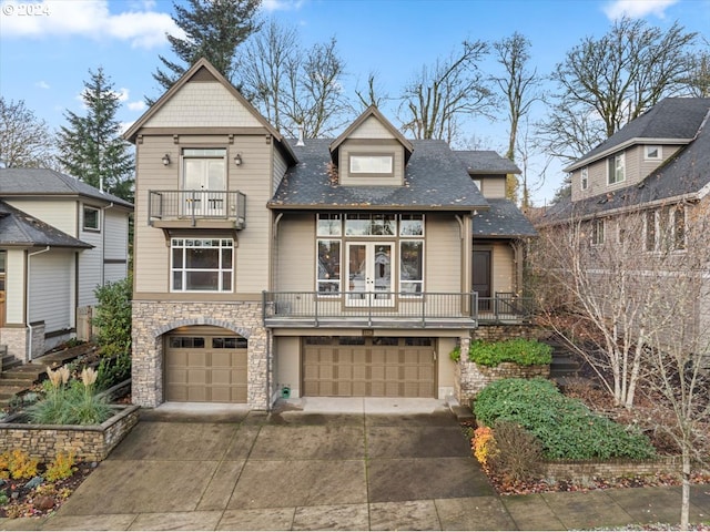 view of front of property with a garage and a balcony