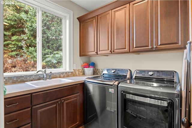 laundry room with sink, cabinets, and washing machine and clothes dryer