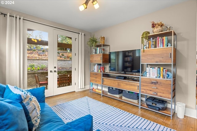 living room featuring hardwood / wood-style flooring and french doors