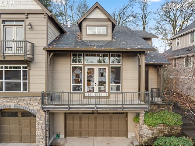 view of front of property featuring a balcony and a garage