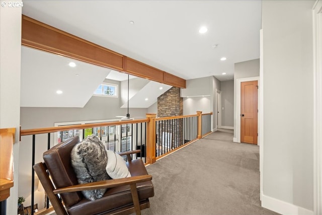 hallway featuring vaulted ceiling with beams and light carpet