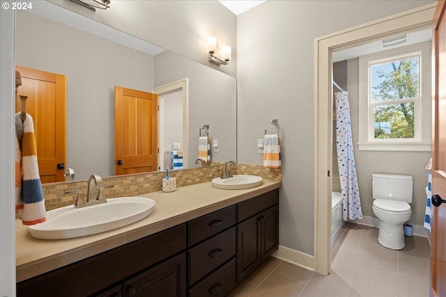 full bathroom featuring tasteful backsplash, tile patterned flooring, vanity, toilet, and shower / bath combo