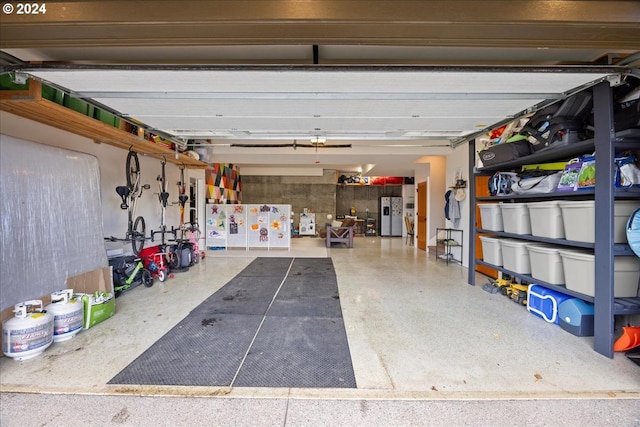 garage featuring stainless steel fridge with ice dispenser