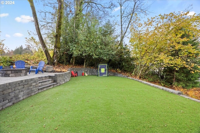 view of yard with a patio and a fire pit