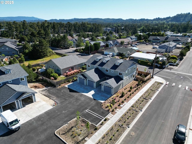 1587 37th St, Florence, OR 97439 - aerial perspective of suburban area featuring a heavily wooded area and a mountainous background