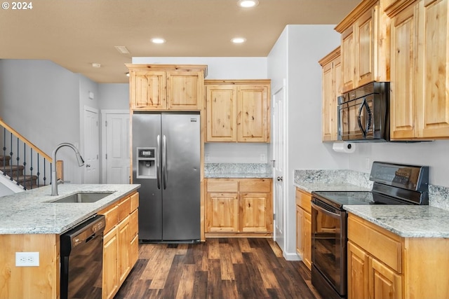 kitchen with sink, light stone counters, dark hardwood / wood-style flooring, light brown cabinetry, and black appliances