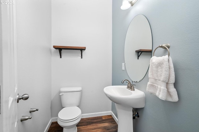 bathroom with toilet and hardwood / wood-style flooring