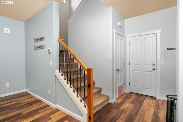 staircase with hardwood / wood-style flooring