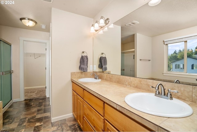 bathroom featuring vanity and a shower with shower door