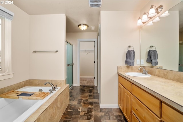 bathroom featuring shower with separate bathtub and vanity