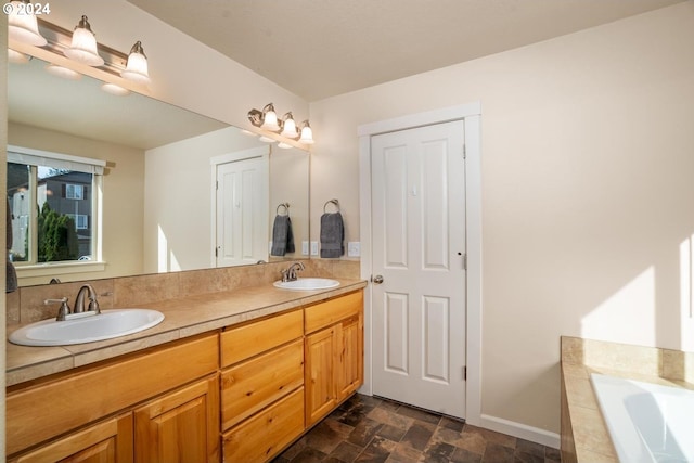 bathroom with vanity and a bath