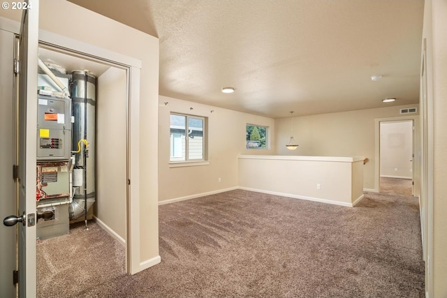 carpeted spare room with a textured ceiling