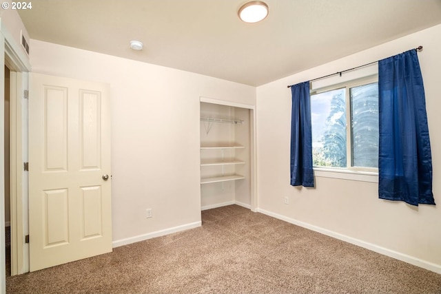 unfurnished bedroom featuring a closet and carpet floors