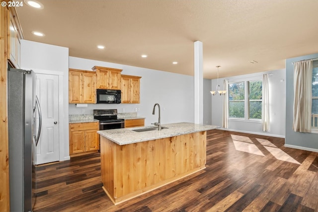 kitchen with light stone countertops, stainless steel appliances, dark hardwood / wood-style floors, a notable chandelier, and a center island with sink