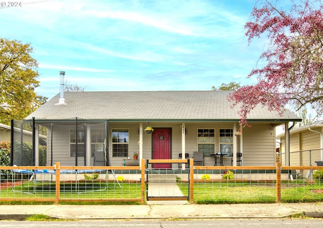 view of front of house with covered porch and a trampoline