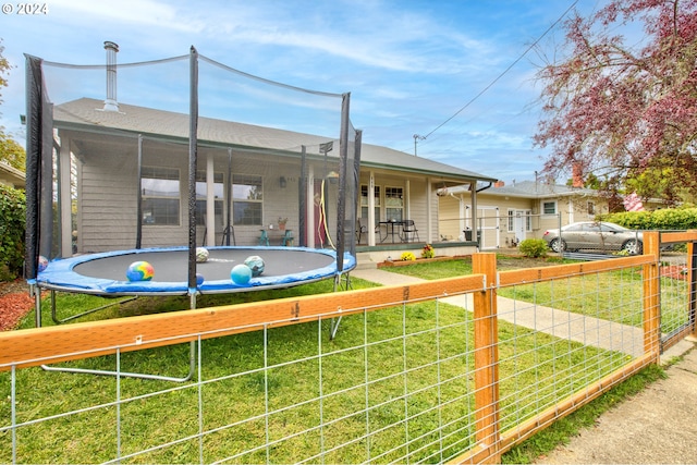 view of front facade featuring a trampoline and a front lawn