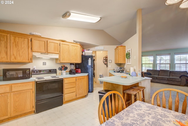 kitchen featuring sink, a kitchen breakfast bar, vaulted ceiling, light brown cabinetry, and black appliances