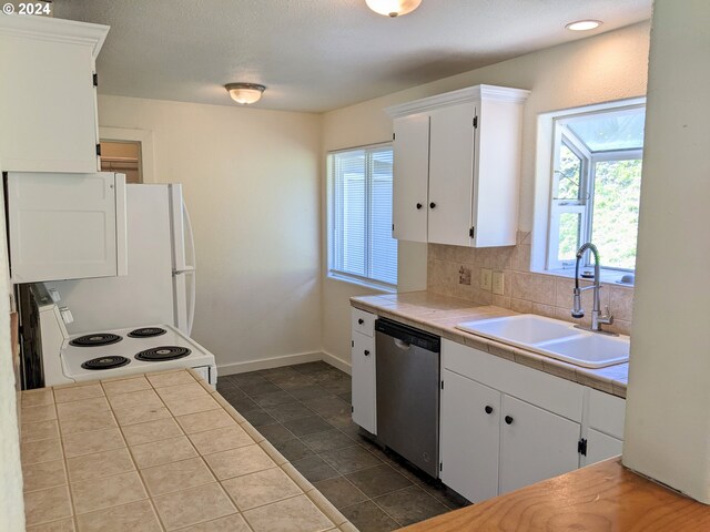 kitchen featuring white range with electric stovetop, tile counters, dishwasher, white cabinets, and sink