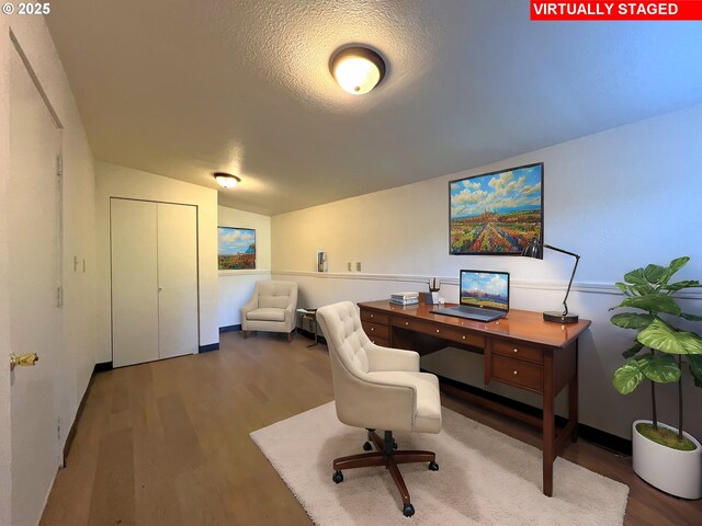 office area featuring a textured ceiling, vaulted ceiling, and hardwood / wood-style flooring