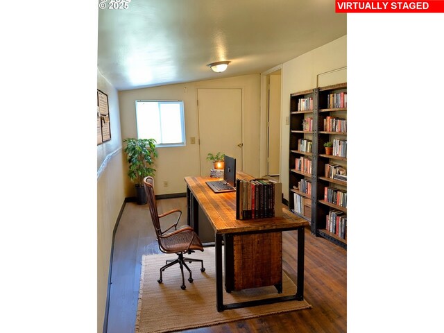 office space featuring vaulted ceiling and dark wood-type flooring