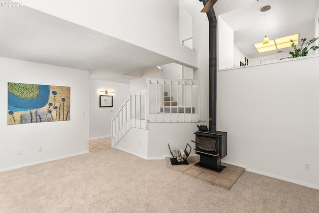 carpeted spare room featuring a high ceiling