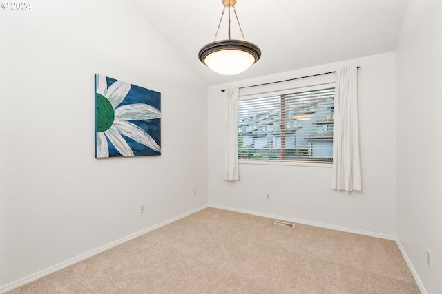 dining room with light carpet and lofted ceiling