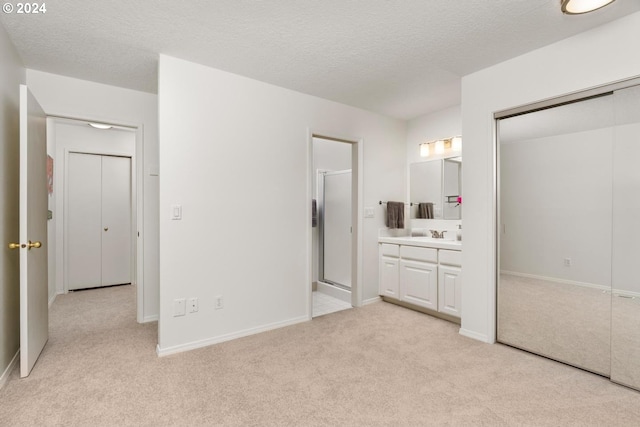 carpeted bedroom featuring sink and a closet