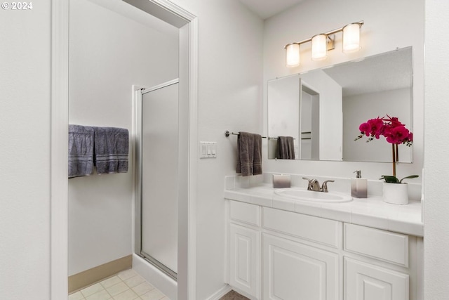 unfurnished bedroom featuring a textured ceiling, light colored carpet, a closet, and ensuite bath