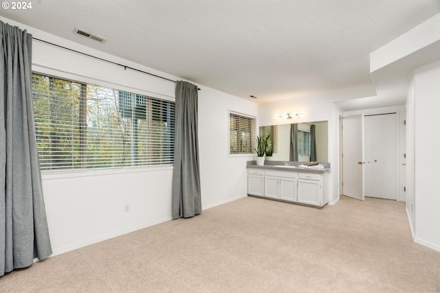 carpeted empty room featuring a textured ceiling