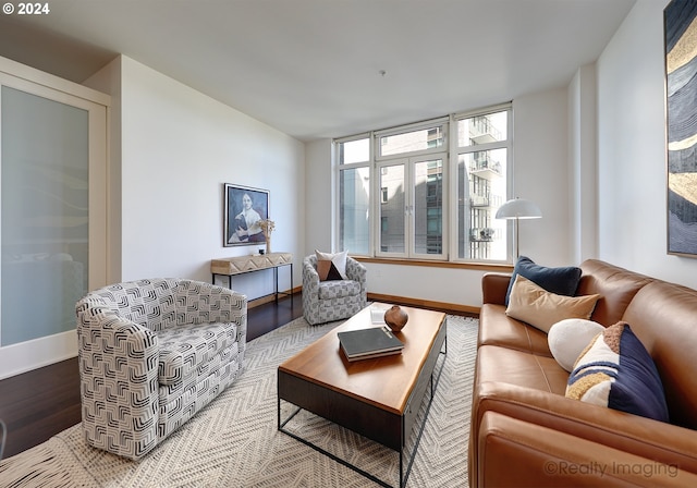 living area featuring baseboards and wood finished floors