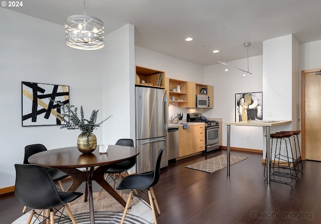 dining space with baseboards, dark wood finished floors, and recessed lighting