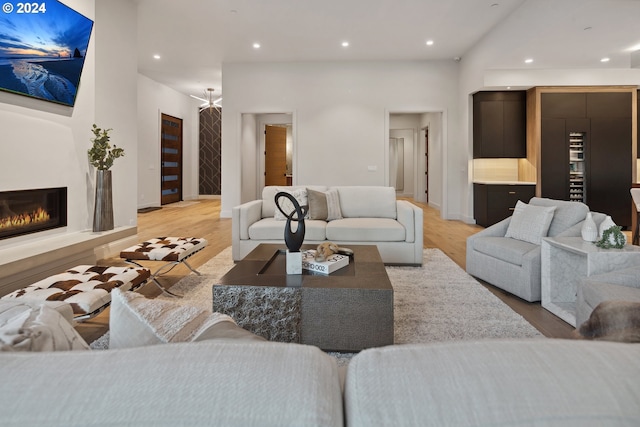 13581 Goodall Rd, Lake Oswego, OR 97034 - living area featuring light wood finished floors, recessed lighting, a glass covered fireplace, and baseboards
