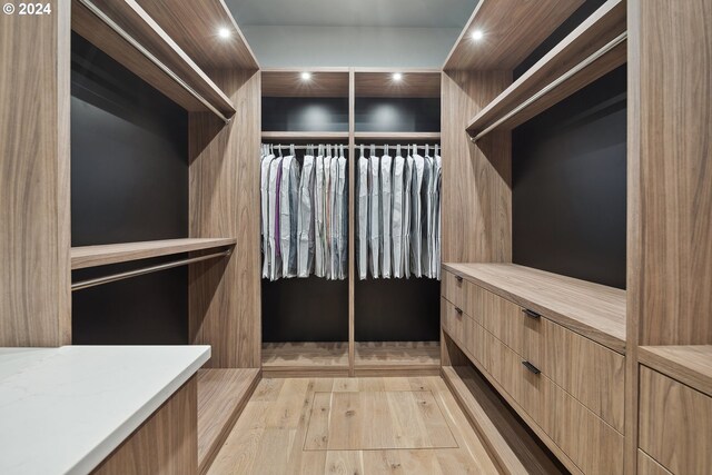 walk in closet featuring light hardwood / wood-style flooring